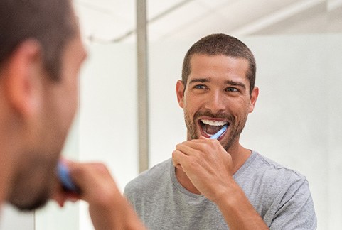 a man brushing his teeth