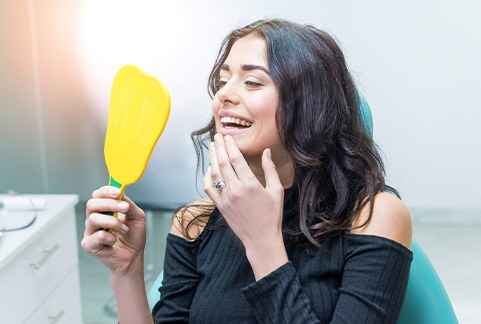 Woman smiling at reflection in mirror