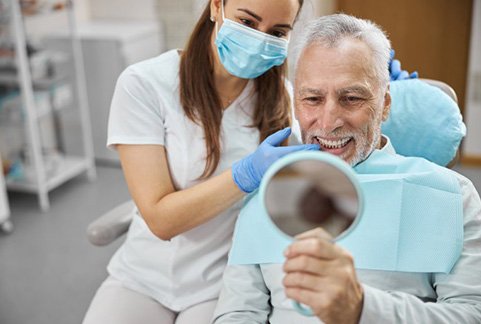 Dentist and patient looking at patient’s dental implants