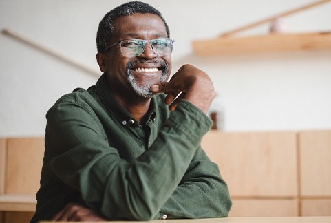 a smiling man with glasses