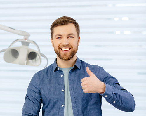 Man in dental office giving a thumbs up