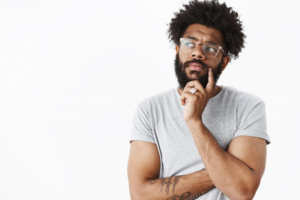 Man tapping finger to his chin as he considers replacing his tooth